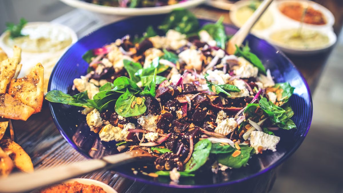 Healthy vegan salad with spinach, tofu, and mixed greens in a bowl, perfect for a nutritious meal.